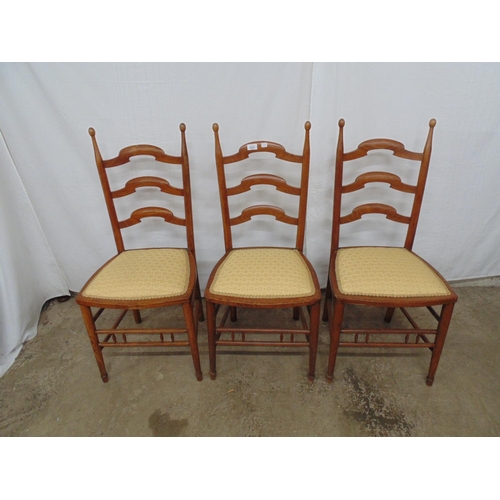 515 - Three walnut ladderback style dining chairs with rounded finials, gold upholstered seats, standing o... 