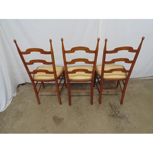 515 - Three walnut ladderback style dining chairs with rounded finials, gold upholstered seats, standing o... 