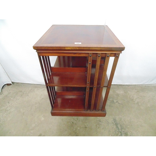 534 - Mahogany revolving bookcase the square top being inlaid and crossbanded over two open tiers with sla... 