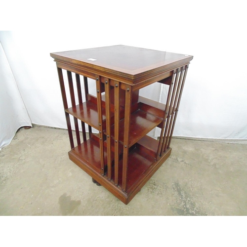 534 - Mahogany revolving bookcase the square top being inlaid and crossbanded over two open tiers with sla... 