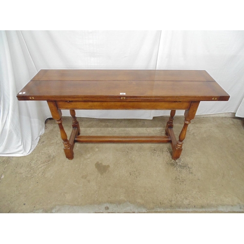 528 - 20th century oak fold over dining table having a three piece hinged top opening onto pull out suppor... 