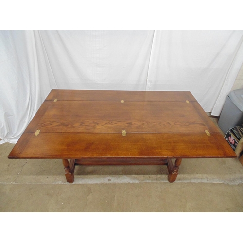 528 - 20th century oak fold over dining table having a three piece hinged top opening onto pull out suppor... 