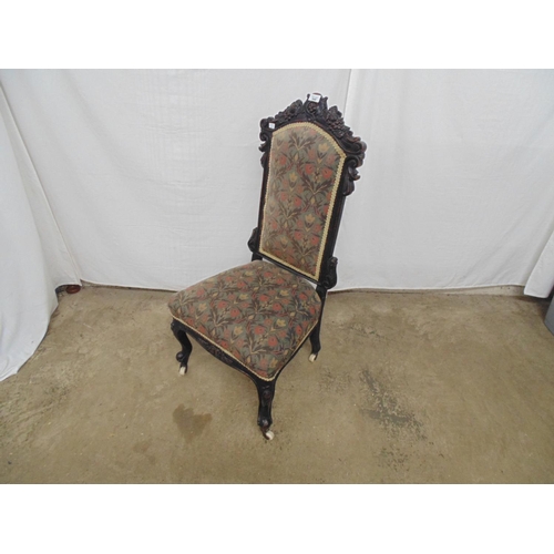 540 - Carved oak side chair having a carved cresting rail, floral upholstered back and seat, standing on c... 