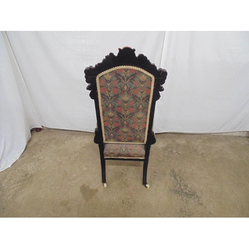 540 - Carved oak side chair having a carved cresting rail, floral upholstered back and seat, standing on c... 