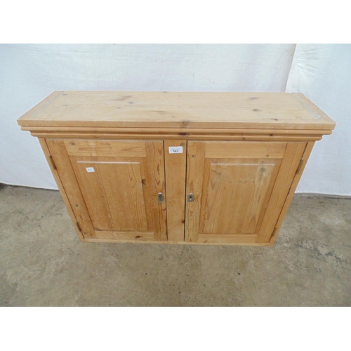 543 - Pine wall cabinet the two panelled doors opening to a single fixed shelf - 81cm x 23cm x 54cm tall