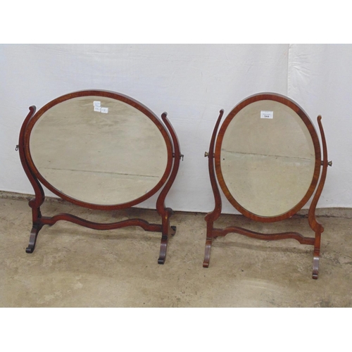 544 - Two mahogany oval bevelled edge swivel mirrors on curved supports - 60cm x 25cm x 57cm tall and 42cm... 