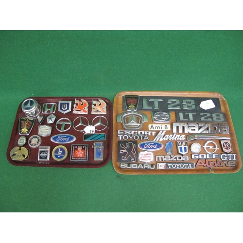 14 - Two trays of metal and plastic vehicle manufacturers badges to include: Ford, Avenger, Golf GTI, Sub... 