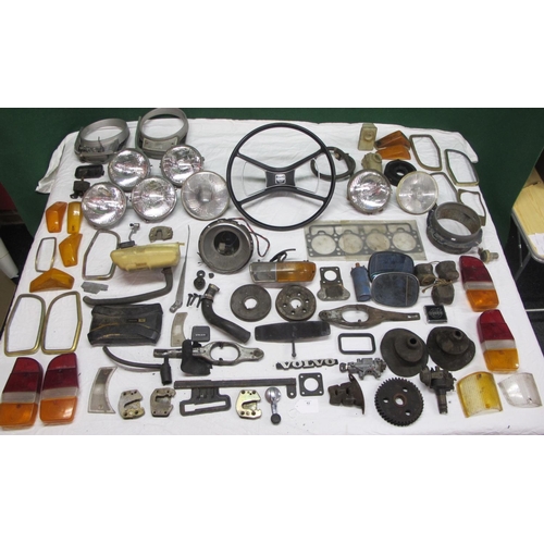 62 - Large quantity of parts from a Volvo 144 to include: head gasket, lamps, badges, lenses, steering wh... 