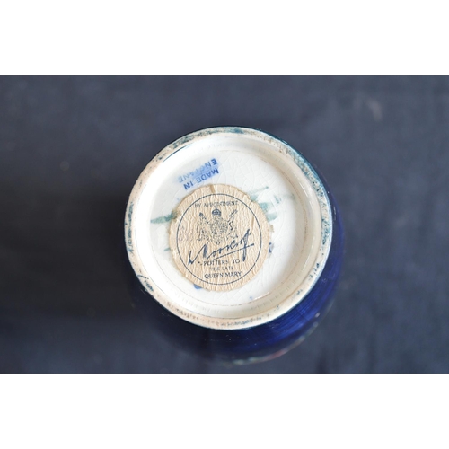 123 - Moorcroft pottery vase in the Anemone pattern on blue ground, signed on base and retaining circular ... 