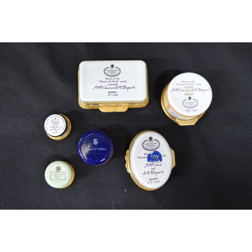 127 - Group of five Halcyon Days enamel trinket boxes (four Winnie the Pooh and floral decorated) together... 