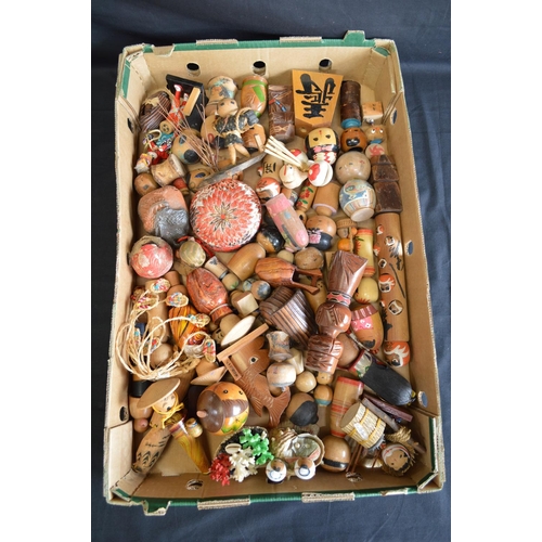182 - Two boxes containing a quantity of Kokeshi and other dolls
