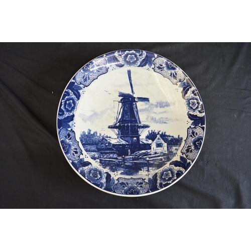189 - Two Delft blue and white wall hanging chargers decorated with scenes of children playing on a frozen... 