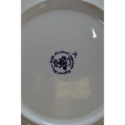 189 - Two Delft blue and white wall hanging chargers decorated with scenes of children playing on a frozen... 