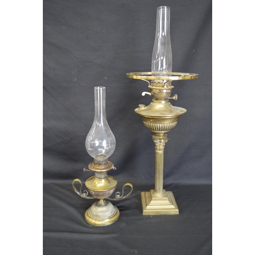 235 - Two brass oil lamps with chimneys - tallest 69cm including chimney