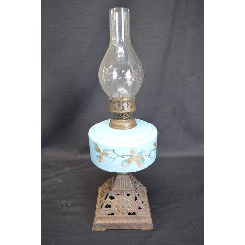 236 - Group of three iron based oil lamps each having glass reservoir and chimney - tallest 57.5cm
