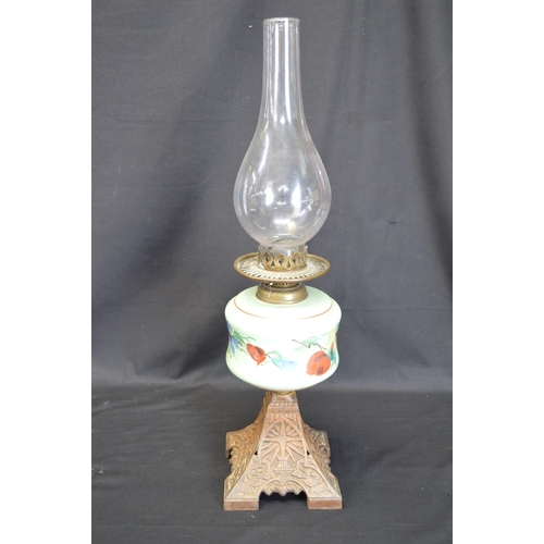 236 - Group of three iron based oil lamps each having glass reservoir and chimney - tallest 57.5cm