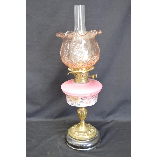 238 - Victorian oil lamp having hand painted glass reservoir supported on brass column and having glass sh... 