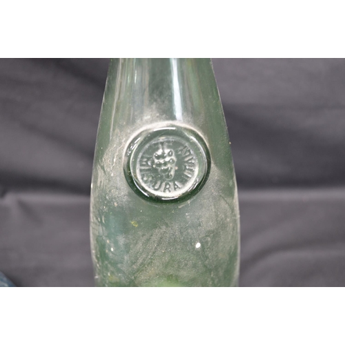 56 - Pale blue Holmgaard glass carafe with Viking face seal - 22cm tall together with a green glass caraf... 