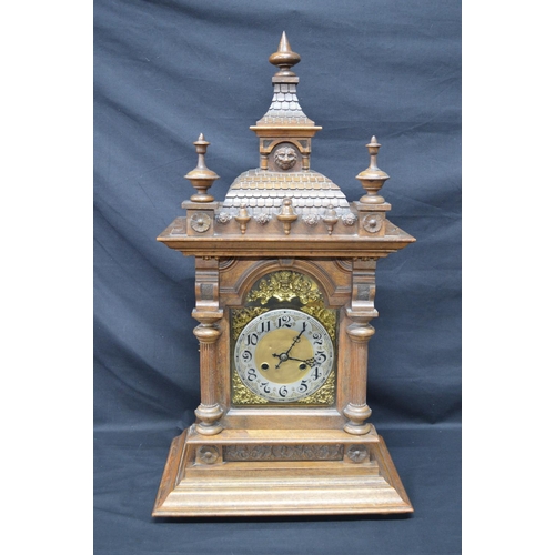 63 - Walnut cased mantle clock of architectural style having brass face with silvered chapter ring, black... 