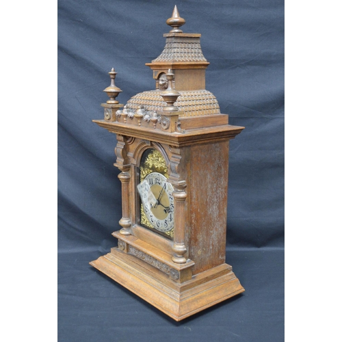 63 - Walnut cased mantle clock of architectural style having brass face with silvered chapter ring, black... 