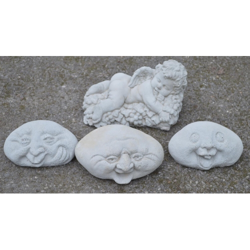 131 - Set of three happy face garden ornaments together with a cherub ornament - 28cm wide