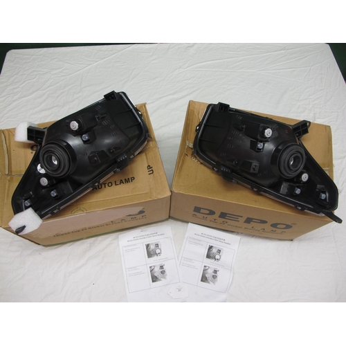 21 - Pair of boxed Toyota Rav4 replacement headlamp units with fitting instructions