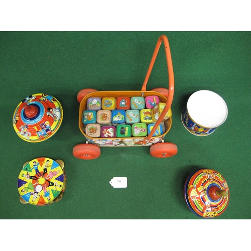 236 - Five colourful tinplate items from Chad Valley - England to comprise: push-a-long trolley containing... 