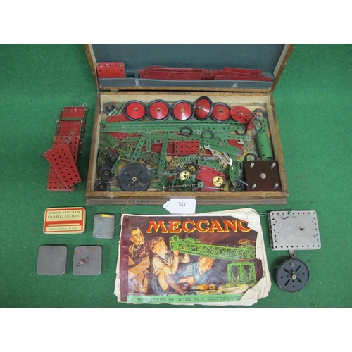 243 - Old wooden cutlery box containing a quantity of Meccano parts, clockwork motor and instructions for ... 