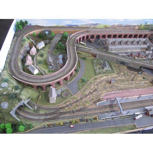 341 - Nivek Town, an N gauge double track continuous run scenic model railway layout with main station, si... 