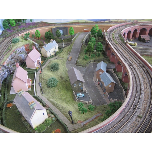 341 - Nivek Town, an N gauge double track continuous run scenic model railway layout with main station, si... 