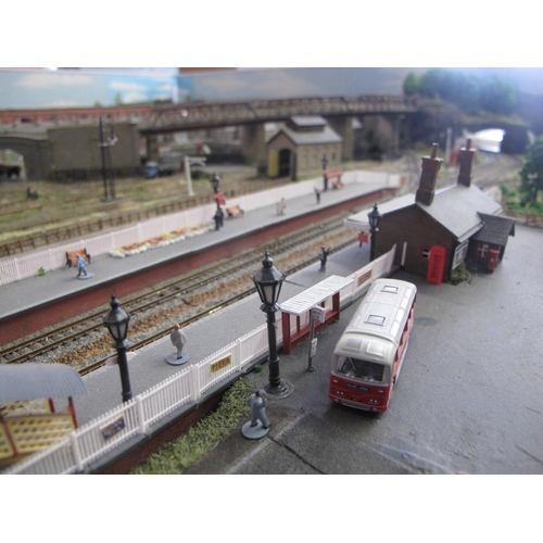 341 - Nivek Town, an N gauge double track continuous run scenic model railway layout with main station, si... 