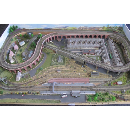 341 - Nivek Town, an N gauge double track continuous run scenic model railway layout with main station, si... 