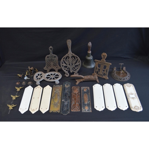 199 - Group of five iron trivets together with a hand bell and finger plates etc