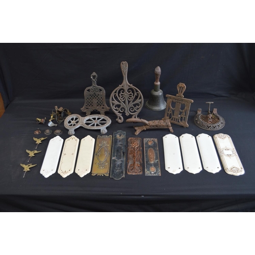 199 - Group of five iron trivets together with a hand bell and finger plates etc