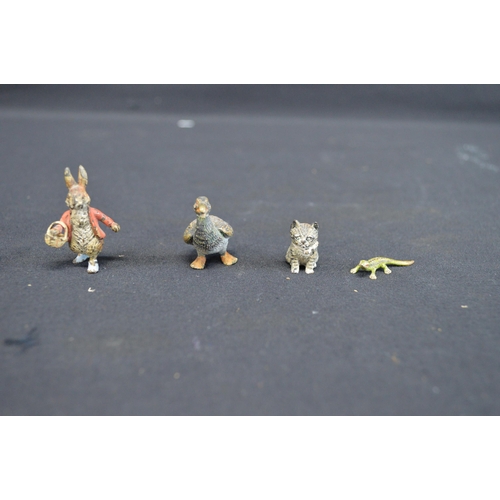 227 - Group of four cold painted bronze figures to comprise: Peter Rabbit - 4cm tall, lizard, kitten and g... 