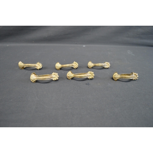 228 - Set of six vintage brass skirt lifters