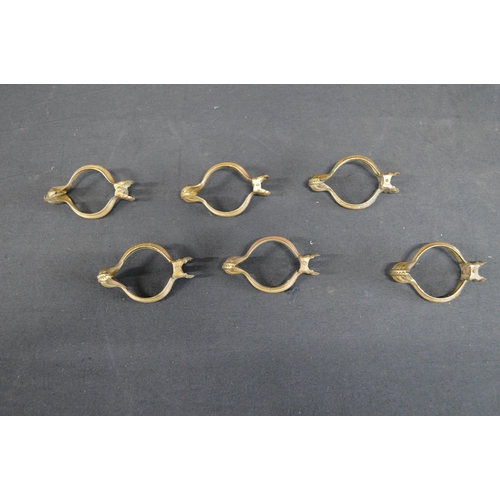 228 - Set of six vintage brass skirt lifters