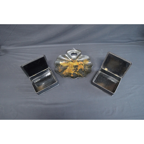 229 - Pair of lacquered papier mache boxes with hinged lids decorated with scenes of figures - 18cm wide t... 