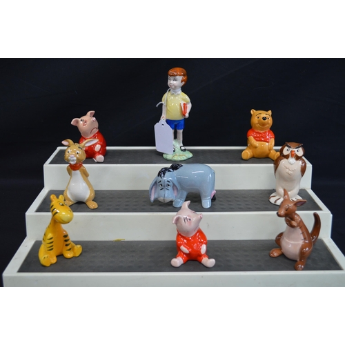 235 - John Beswick group of nine Winnie the Pooh figures to comprise: Christopher Robin, Winnie the Pooh, ... 