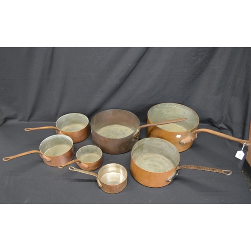 128 - Group of seven copper saucepans with riveted handles