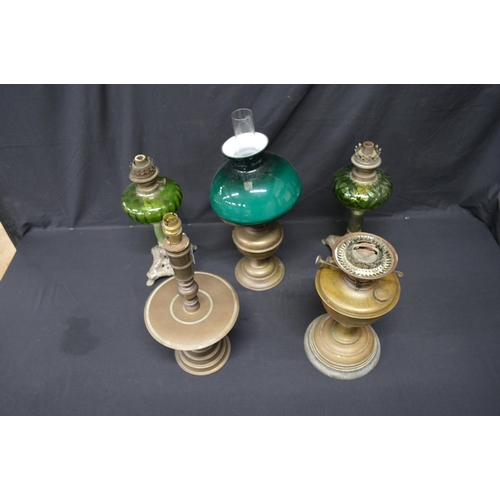 138 - Group of four various oil lamps together with a brass table lamp