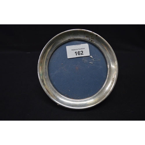 162 - Circular silver photograph frame, hallmarked for Birmingham - 13.5cm wide together with one other si... 