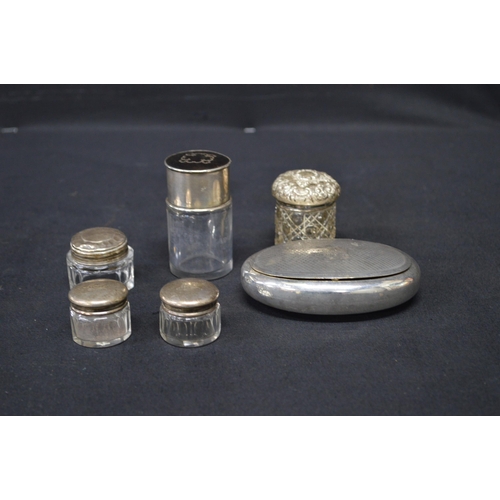 166 - Group of five small silver top glass pots together with white metal snuff box of oval shape