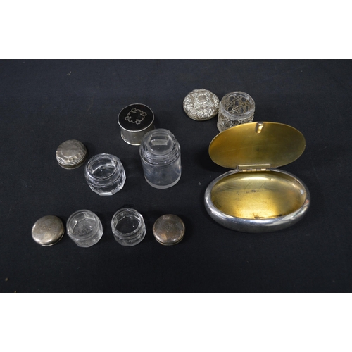 166 - Group of five small silver top glass pots together with white metal snuff box of oval shape