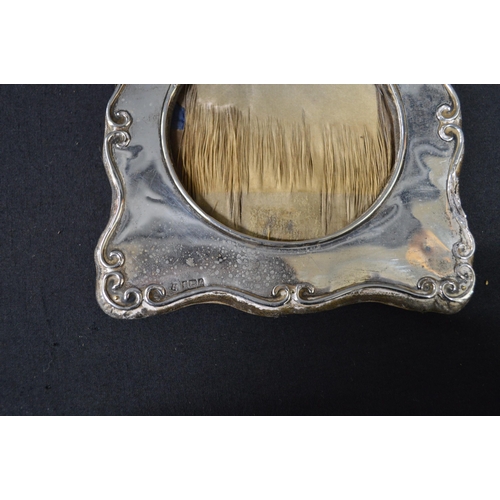 167 - Oval silver photograph frame, hallmarked for Birmingham - 21cm wide together with one other silver p... 