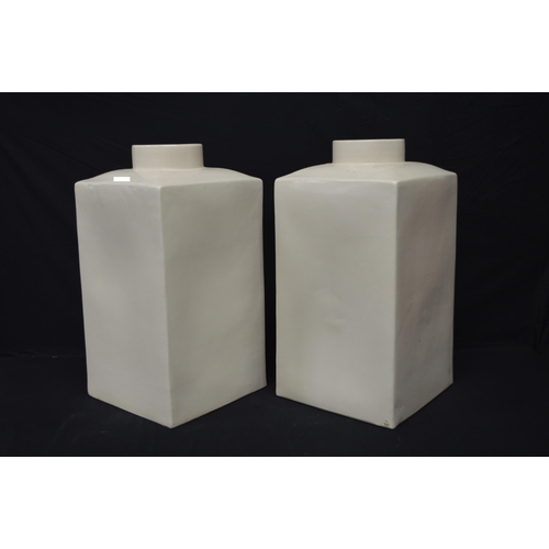 185 - Pair of square form cream ground floor vases - 57.7cm tall