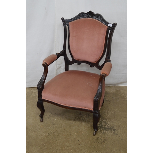 271 - Dark stained open armchair having carved cresting rail, padded back, seat and arm rests, standing on... 