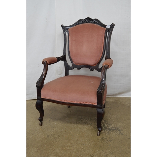 271 - Dark stained open armchair having carved cresting rail, padded back, seat and arm rests, standing on... 