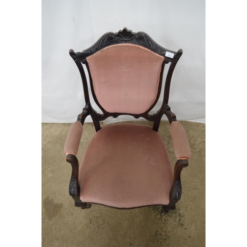 271 - Dark stained open armchair having carved cresting rail, padded back, seat and arm rests, standing on... 