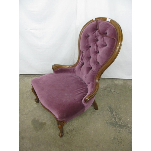 275 - Walnut button back nursing chair having padded back and seat, standing on carved cabriole front legs... 